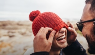 אישה עם תיק גב מחייכת הולכת עם חבר באזור כפרי