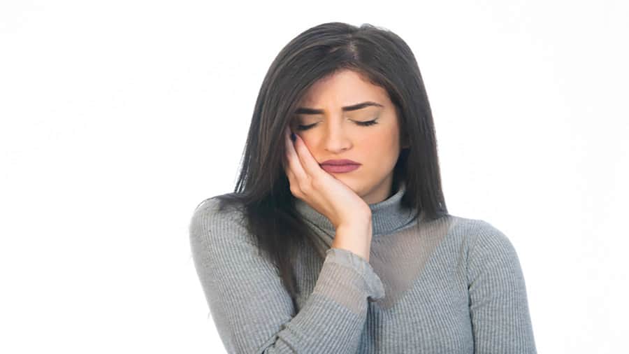 אישה צעירה סובלת מכאב שן